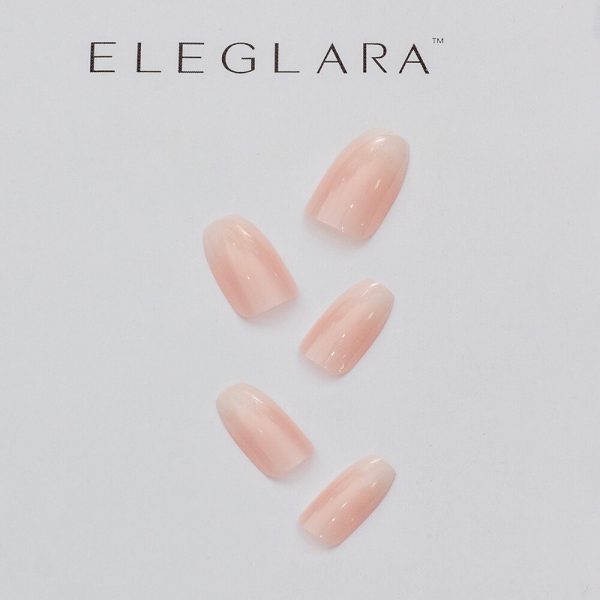 Five nude pink ombré press-on nails arranged on a white Eleglara background