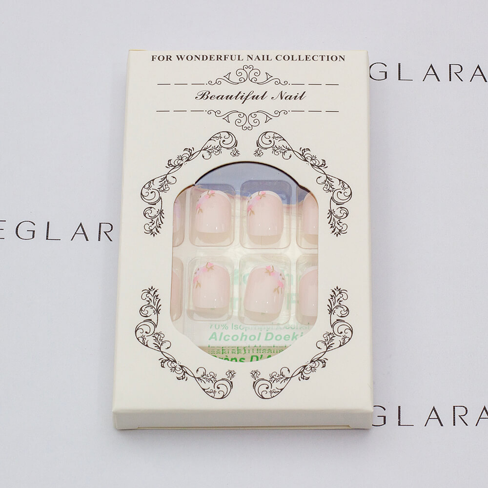 Eleglara Beauty packaging for blush pink floral short almond press-on nails, ornate white box labeled "Beautiful Nail" with floral motifs, revealing the 24-nail set, Jelly Gel tabs, alcohol prep pad, and nail file inside against a pristine white backdrop.
