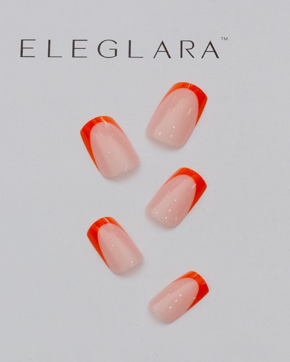 Five short square press-on nails with vibrant orange french tips on a creamy nude base, arranged neatly on a white background with the Eleglara Beauty logo, glossy finish highlighting the bold, cute design for fall chic.