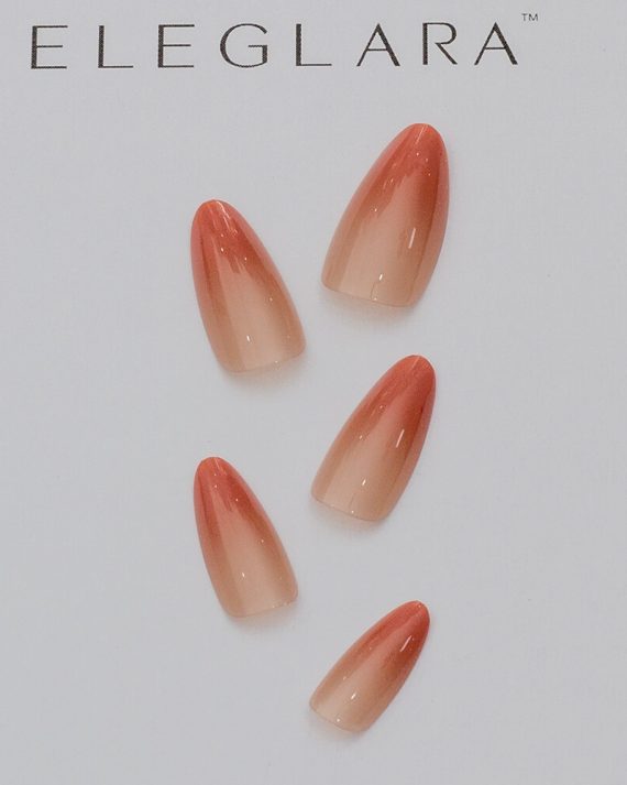 Five medium almond press-on nails with coral gradient from orange tip to soft nude base, arranged on a white background with the Eleglara logo, glossy finish showcasing the warm, boho design.